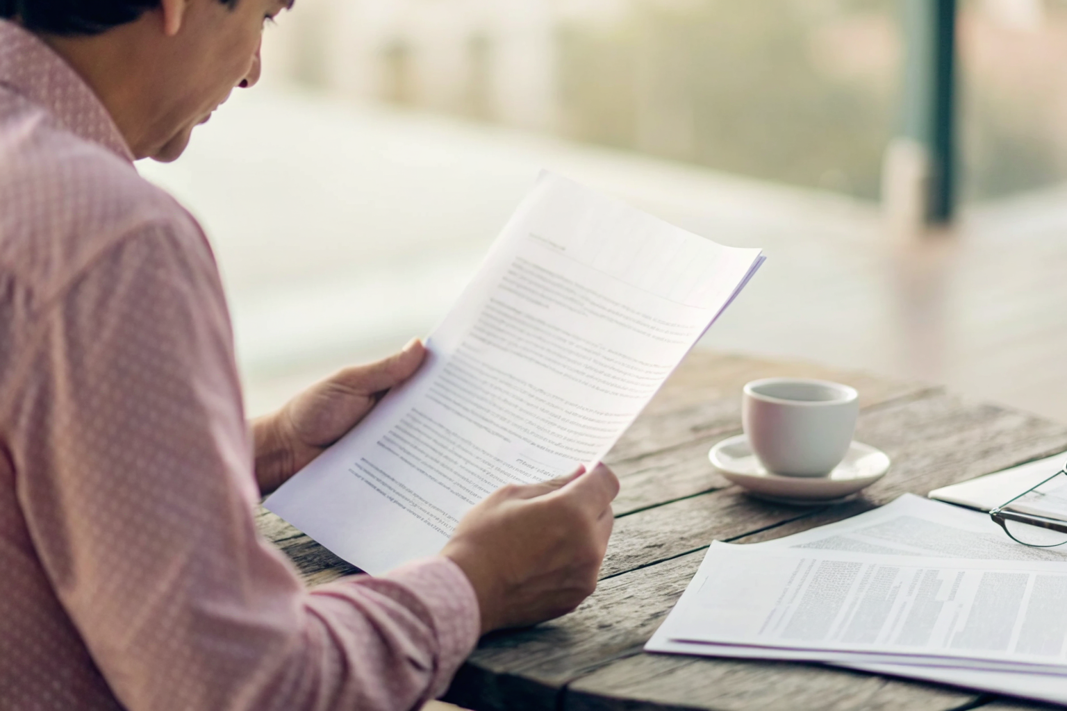 Person reviewing insurance documents to identify coverage gaps.