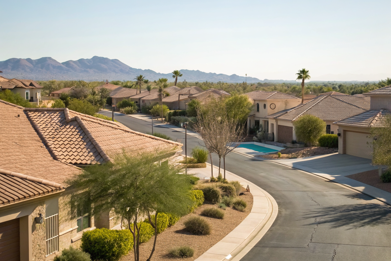 Chandler street with tile roofs, pools, and desert landscape.