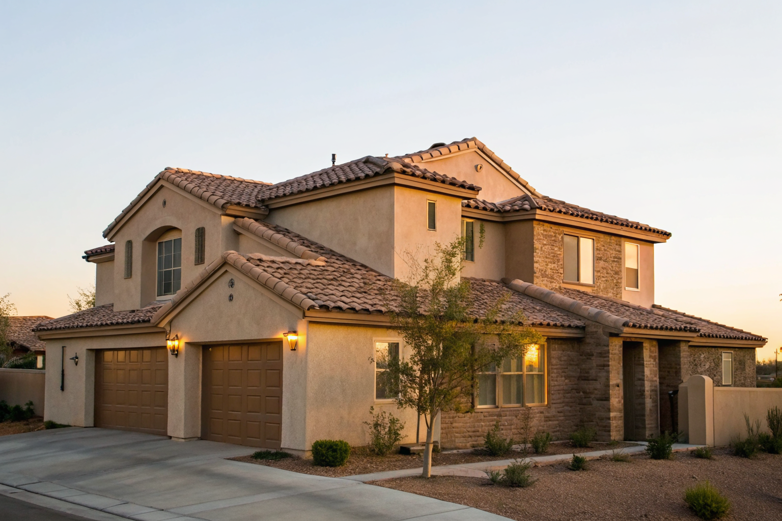 Suburban Arizona home with tile roof and stucco walls at golden hour.