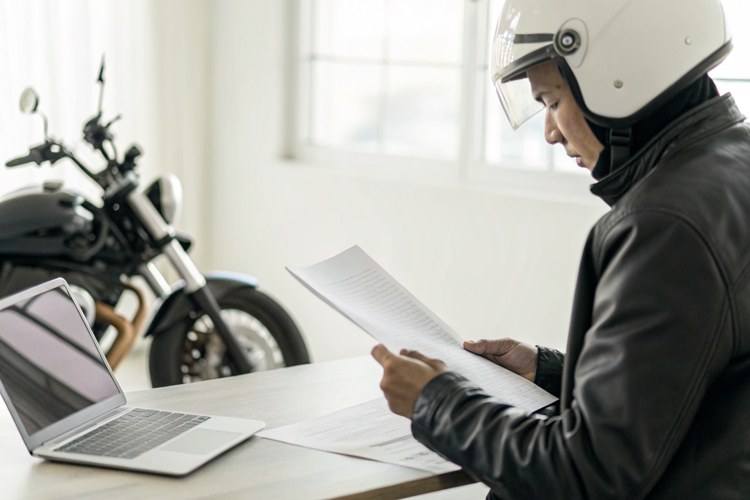 Motorcyclist reviewing helmet documentation for Arizona insurance claims.