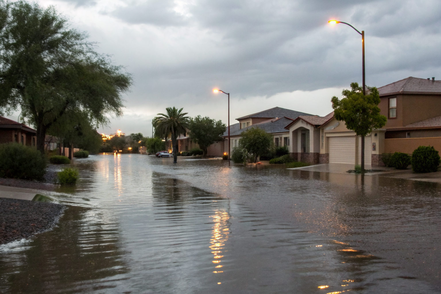 Flooded street in Arizona with houses affected by water exclusion.