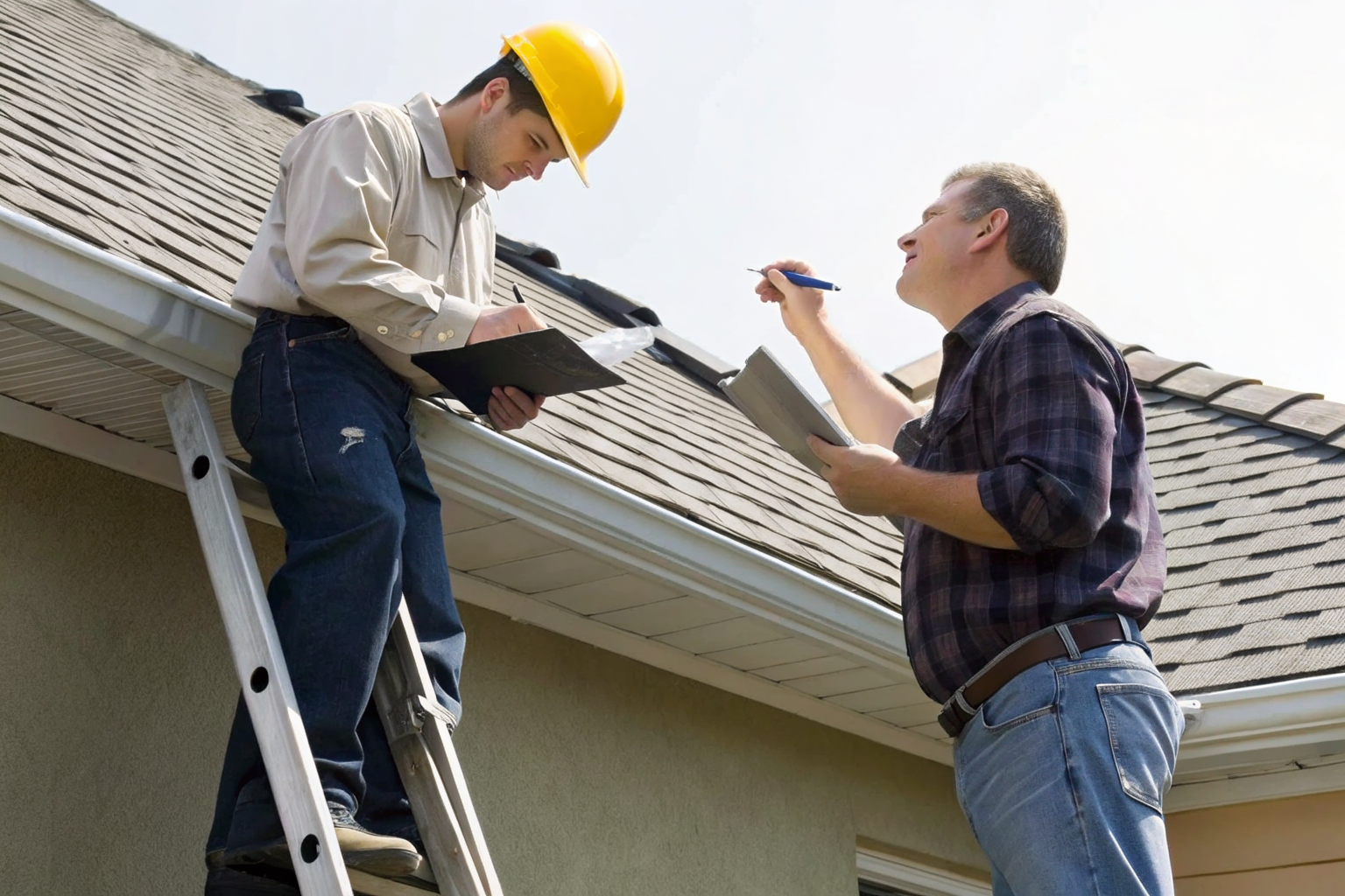 Homeowner and contractor inspecting roof condition.
