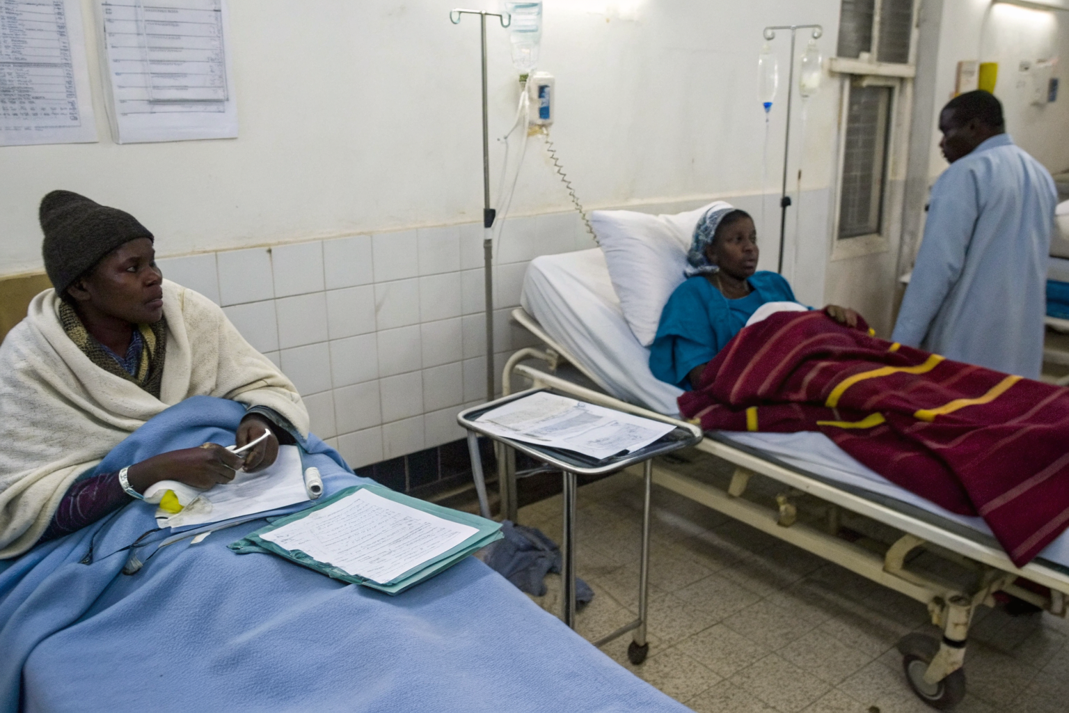 Emergency room scene with patients and visible medical bills.