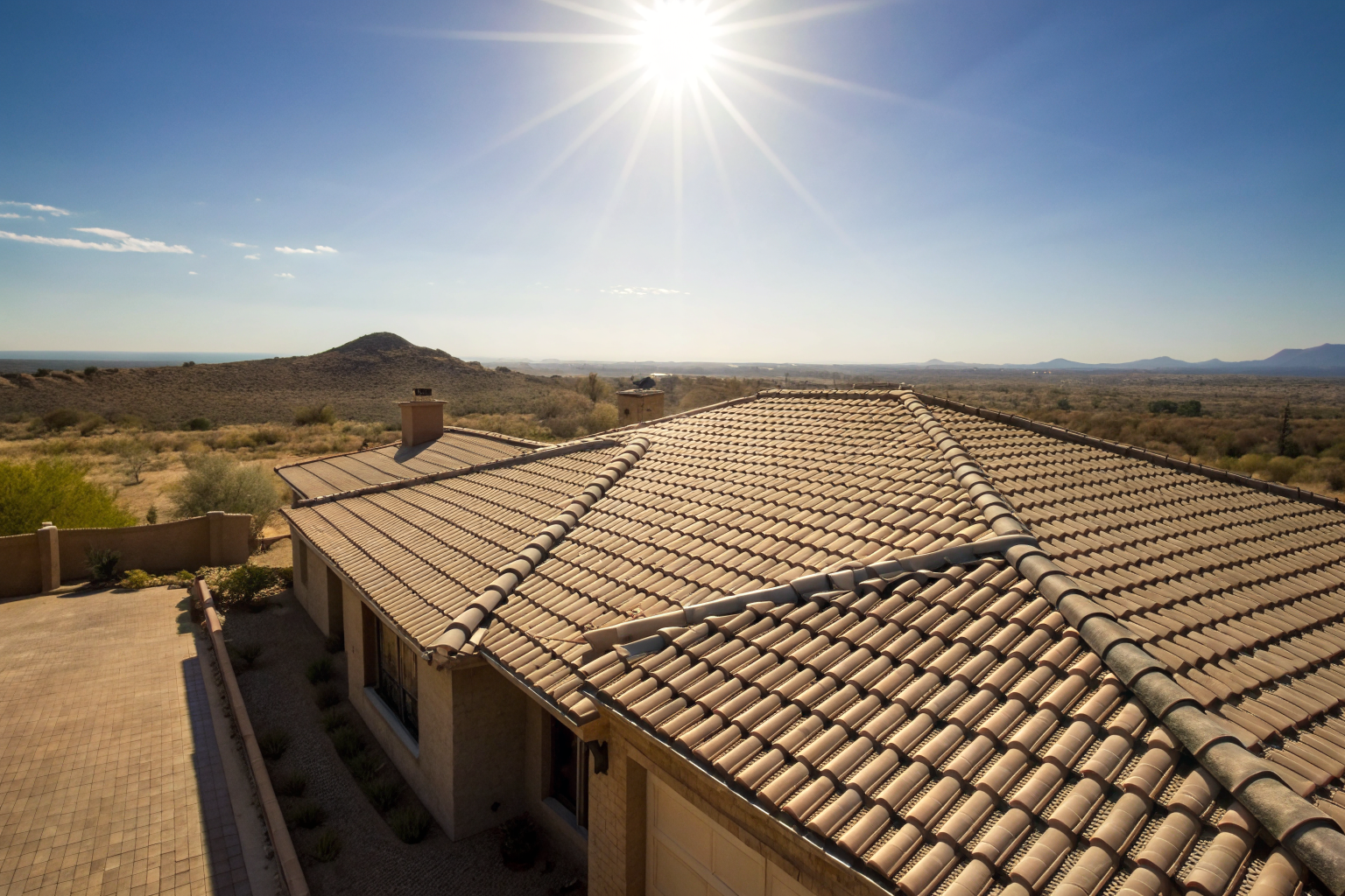 Tile-roofed house in Arizona under bright sunlight, showing detailed texture.