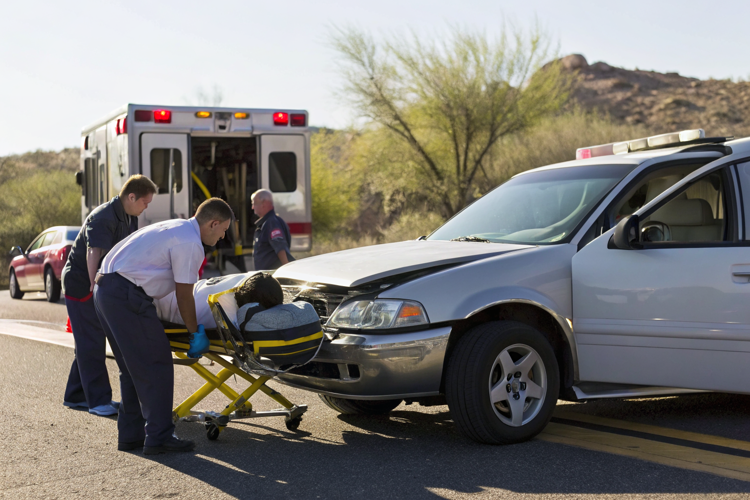 Driver and passenger receive medical attention with MedPay documents present.