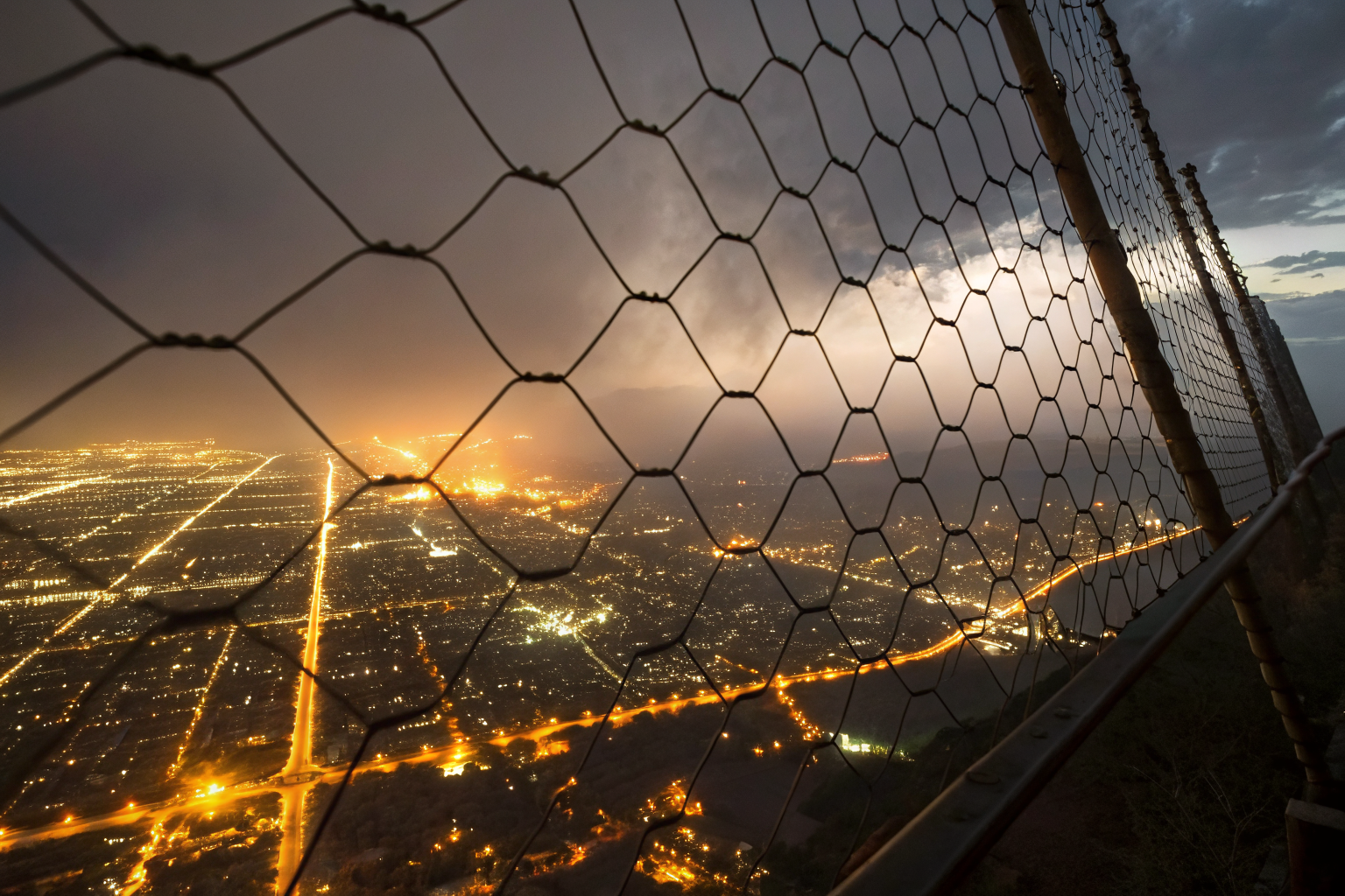 Cinematic firewall net over city, holes representing cyber coverage gaps.