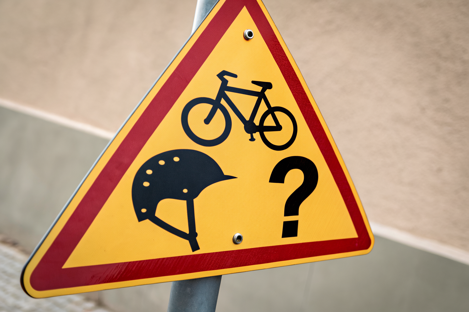 Traffic sign with question marks symbolizing misunderstandings of Arizona's helmet laws and e-bike rules.